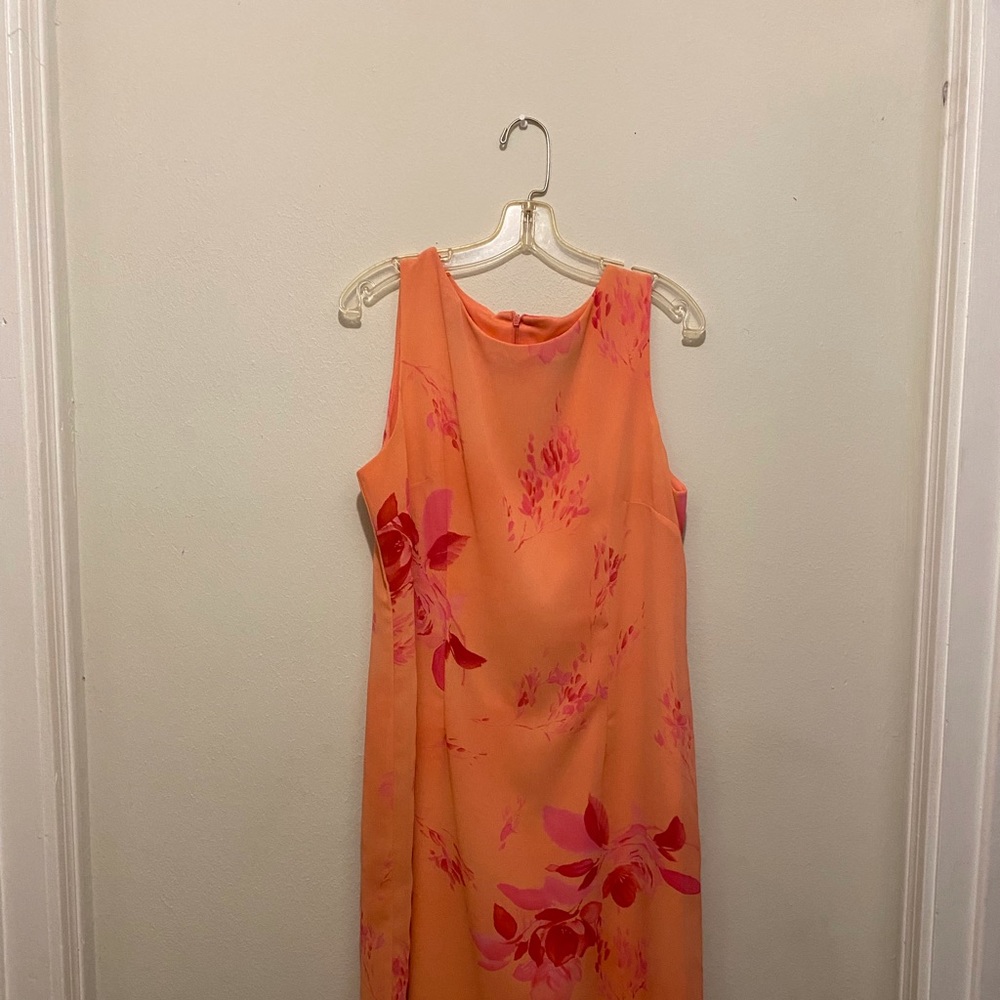 Orange dress mid length to knee area, size 16, zips up the back.